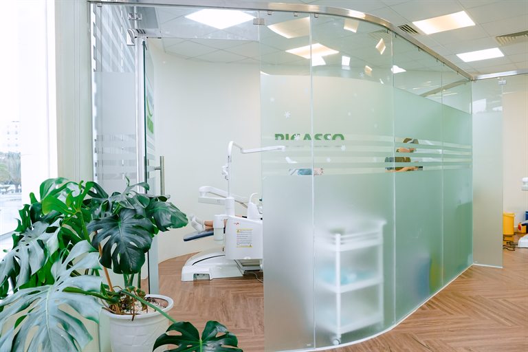 Glass-partitioned treatment room at Vinmec Picasso Dental